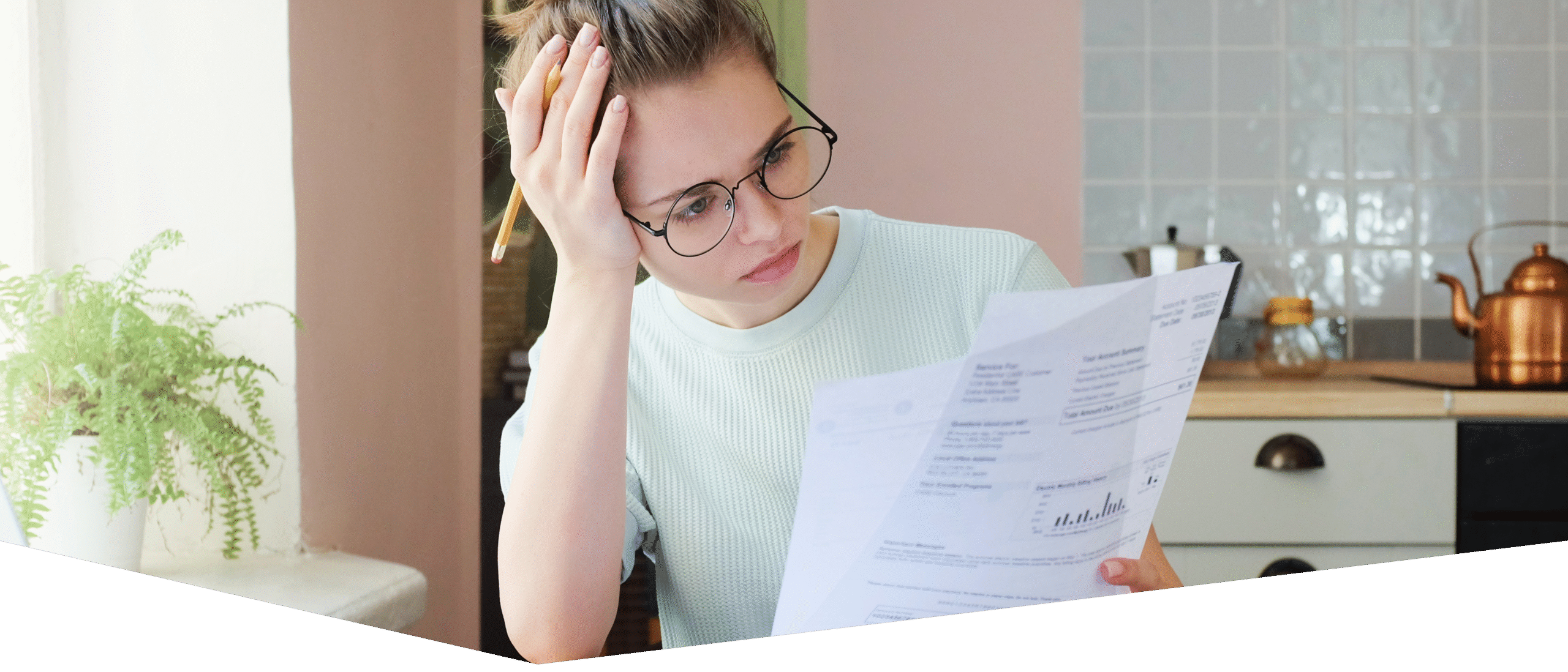 Indoor shot of young European Caucasian girl looking at financial documents at home with deeply bored face looking sick and tired of her economic problems, trying to check counts and all details
