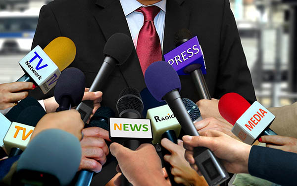 Media and press interview with group of journalists surrounding